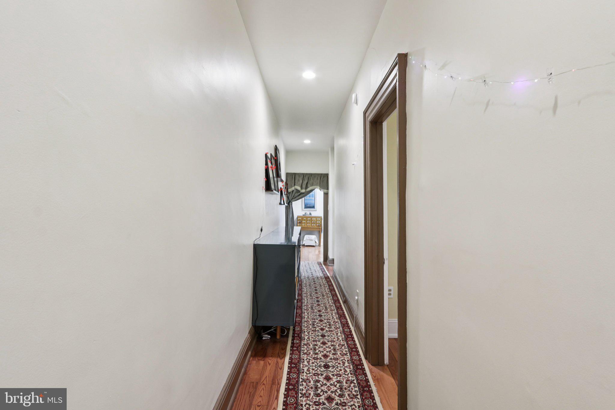 1003 South 46th Street, Unit 4 Philadelphia, PA 19143 - Photo 11 of 32 a view of a hallway with wooden floor and staircase