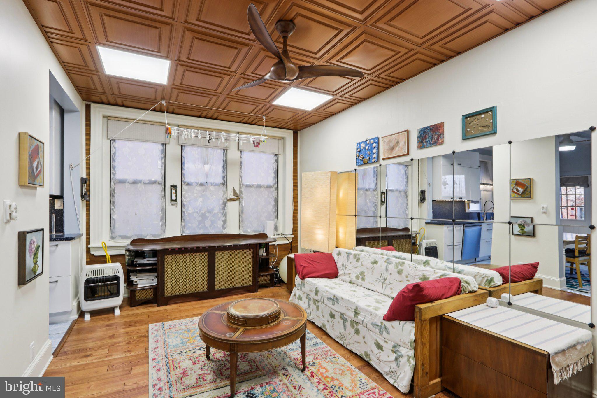 1003 South 46th Street, Unit 4 Philadelphia, PA 19143 - Photo 13 of 32 a living room with furniture a rug and a table