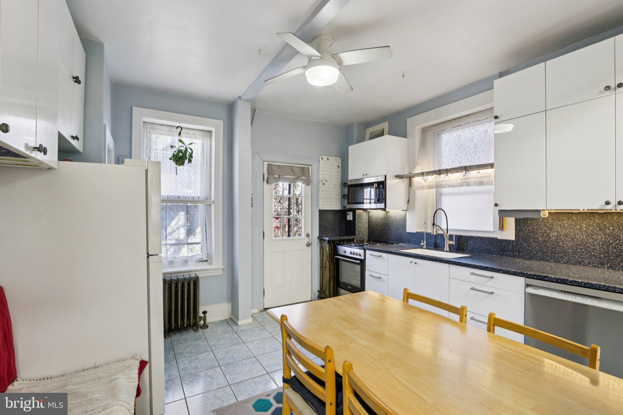 1003 South 46th Street, Unit 4 Philadelphia, PA 19143 - Photo 16 of 32 a kitchen with granite countertop a sink appliances cabinets and furniture