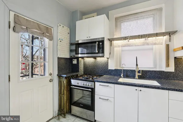 a kitchen with stainless steel appliances a refrigerator sink and stove