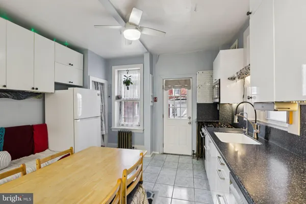 a white refrigerator freezer and a stove sitting inside of a kitchen