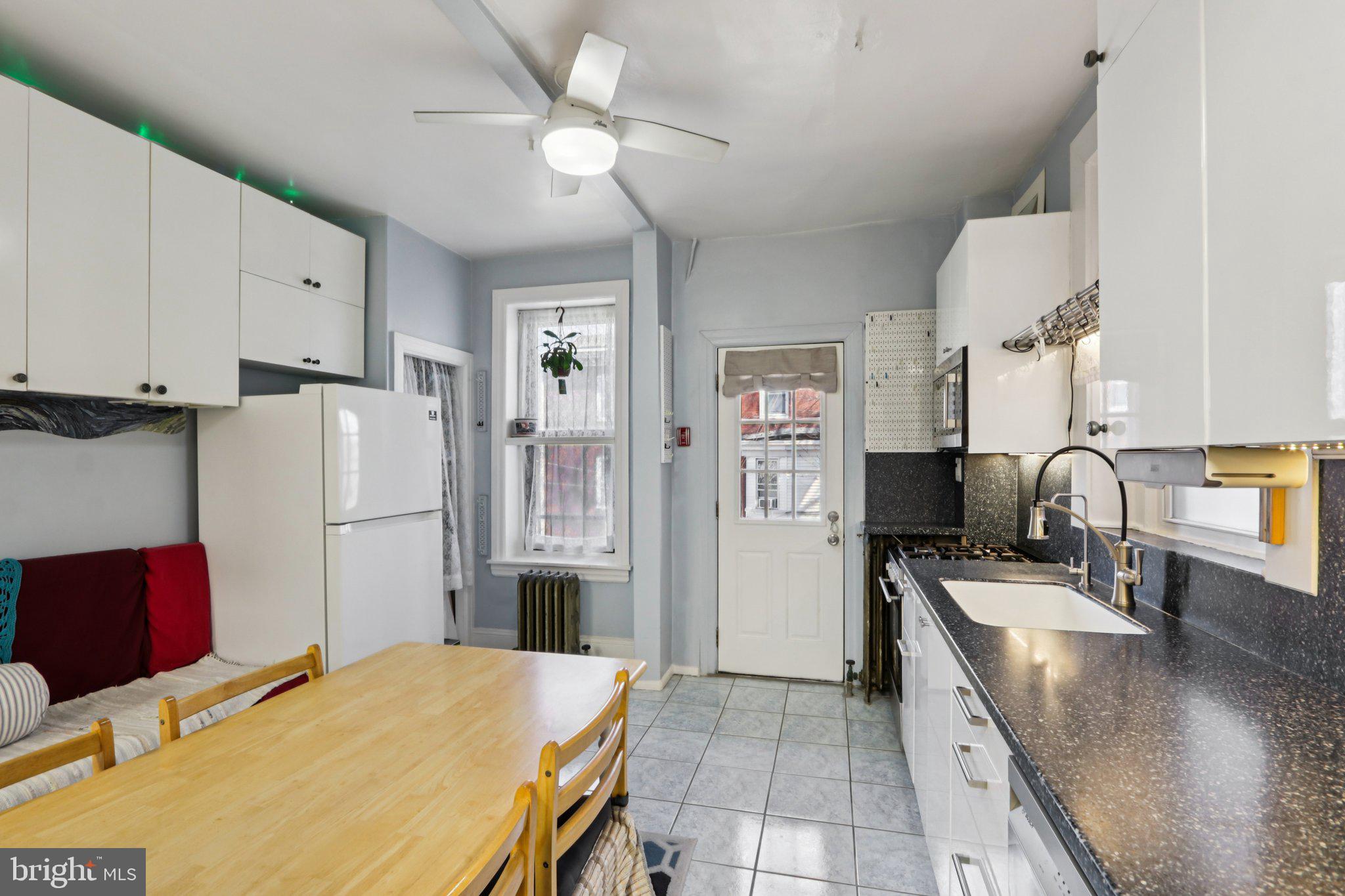 1003 South 46th Street, Unit 4 Philadelphia, PA 19143 - Photo 18 of 32 a kitchen with stainless steel appliances a refrigerator sink and stove
