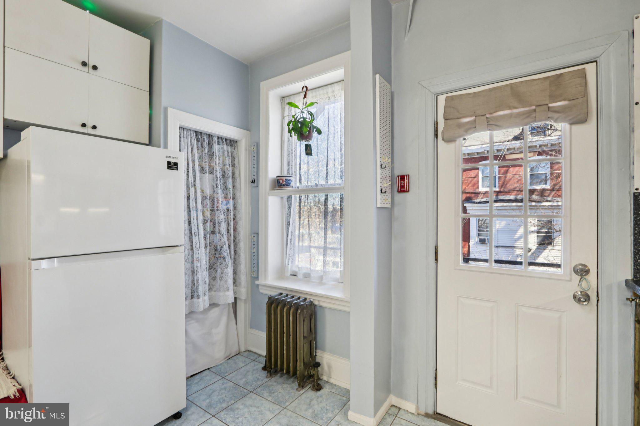 1003 South 46th Street, Unit 4 Philadelphia, PA 19143 - Photo 19 of 32 a white refrigerator freezer and a stove sitting inside of a kitchen