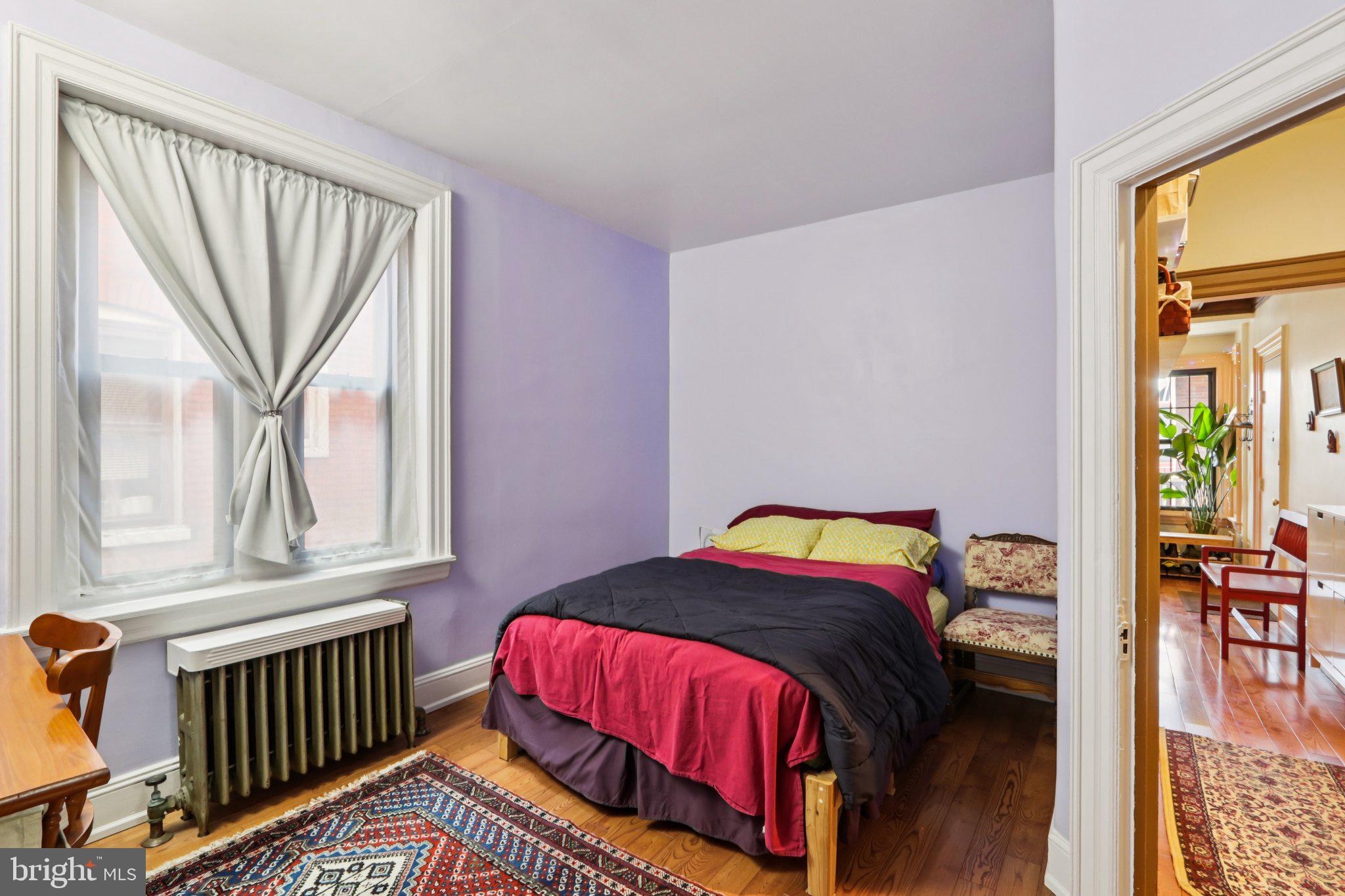 1003 South 46th Street, Unit 4 Philadelphia, PA 19143 - Photo 27 of 32 a bedroom with a bed and a window