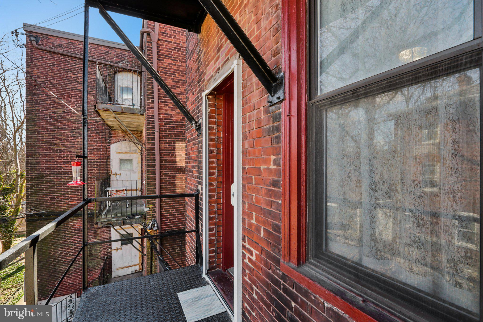1003 South 46th Street, Unit 4 Philadelphia, PA 19143 - Photo 29 of 32 a front view of a house with a glass door and glass door