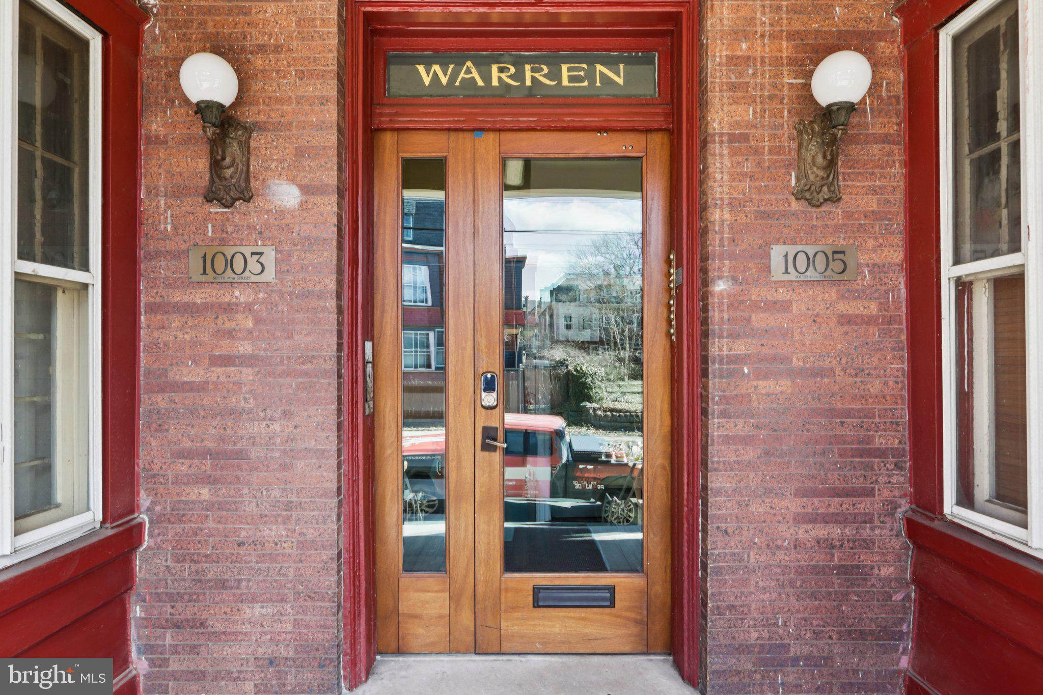1003 South 46th Street, Unit 4 Philadelphia, PA 19143 - Photo 4 of 32 a view of a brick building with a door and a window