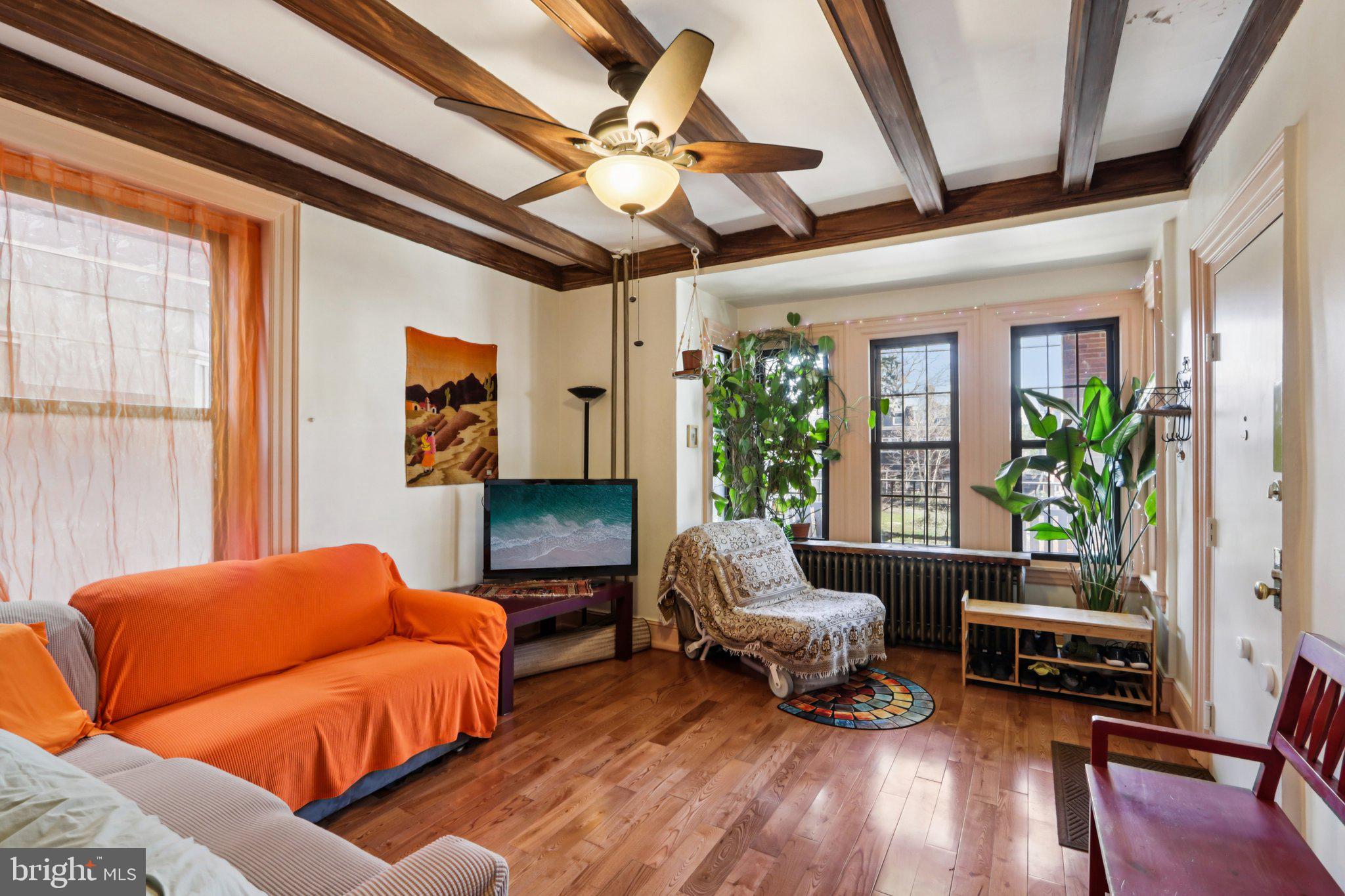 1003 South 46th Street, Unit 4 Philadelphia, PA 19143 - Photo 7 of 32 a bedroom with furniture and a large window