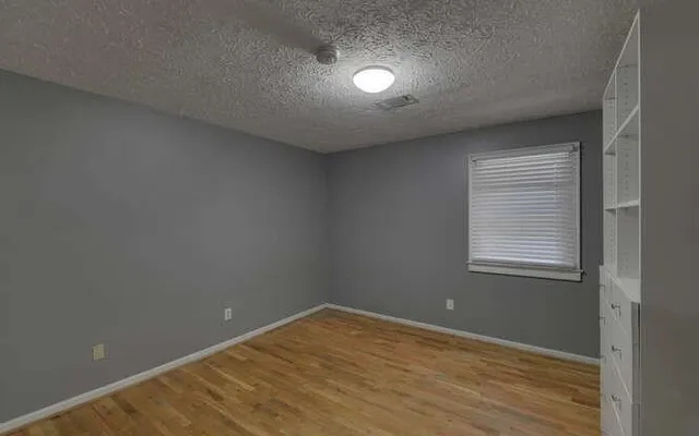 an empty room with closet area