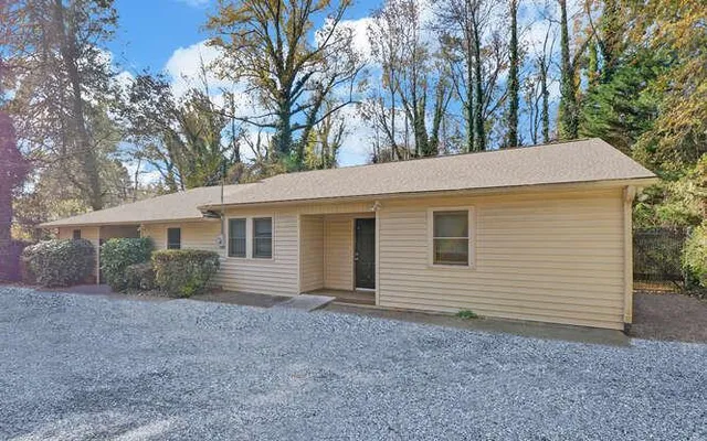 a view of a house with a backyard