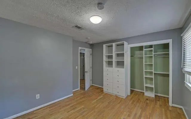 a view of a hallway view with wooden floor and staircase