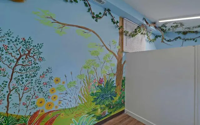 a view of a hallway with stairs and wooden floor