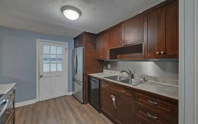 a kitchen with stainless steel appliances granite countertop a stove and a refrigerator