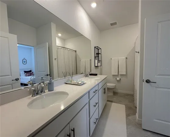 a bathroom with a double vanity sink mirror double and shower