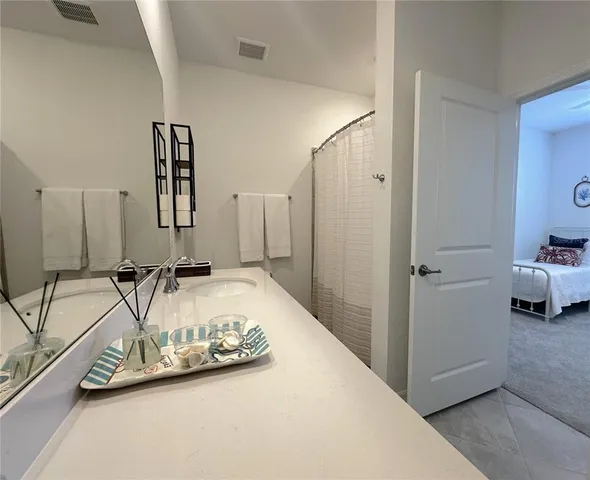 a view of a bedroom with a large bed and a couch