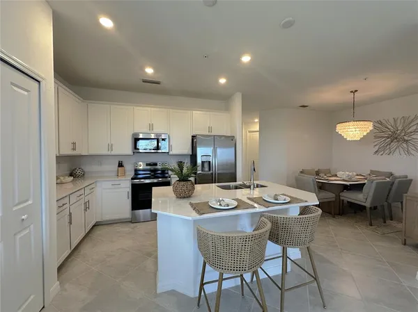 a kitchen with granite countertop sink dining table and chairs