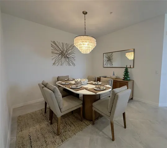 a view of a dining room with a table and chairs