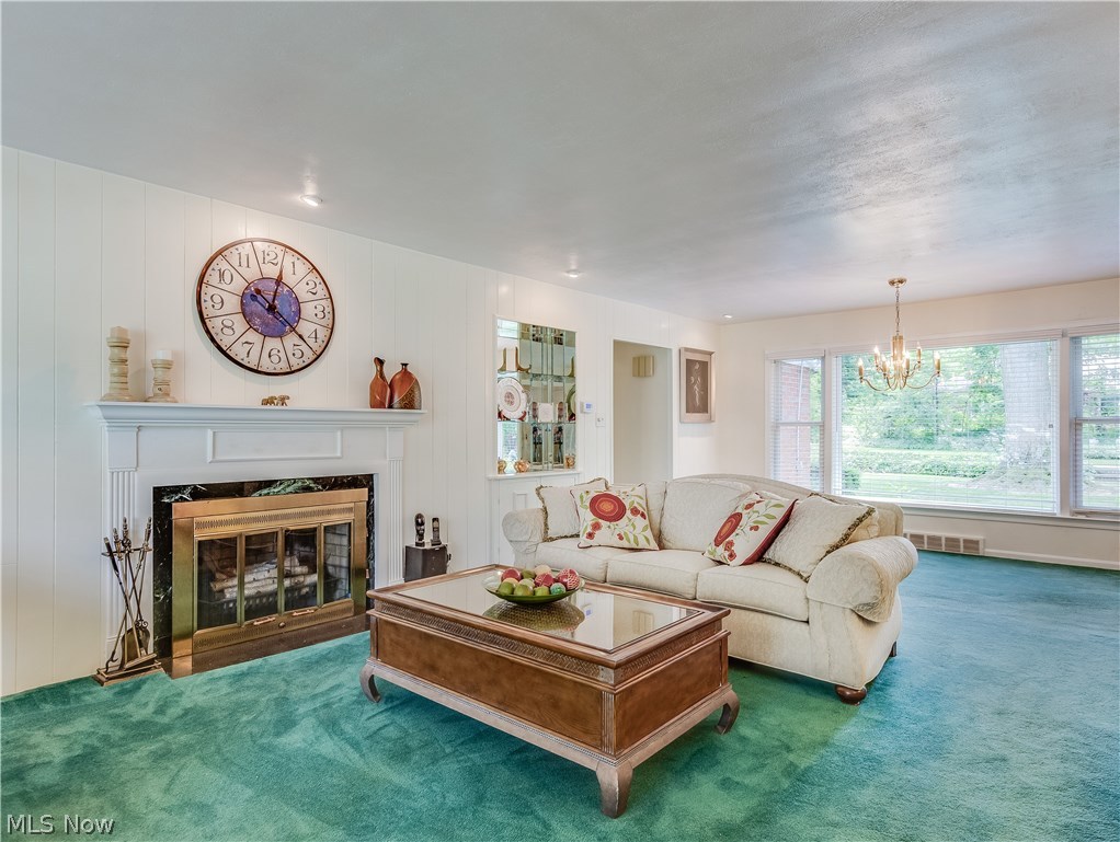 1072 Brandon Road Cleveland, OH 44112 - Photo 3 of 24 Open, 27 x 15 foot Living Room features Big Windows on both sides, Wood-Burning Fireplace and a Dining Area.