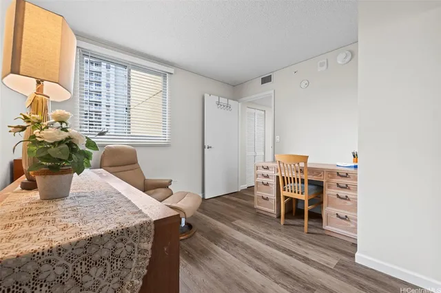 a bedroom with furniture and a wooden floor