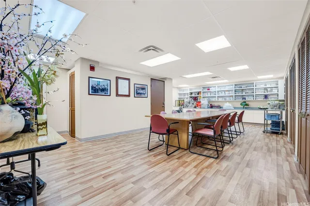 a view of a big building with big yard and large trees
