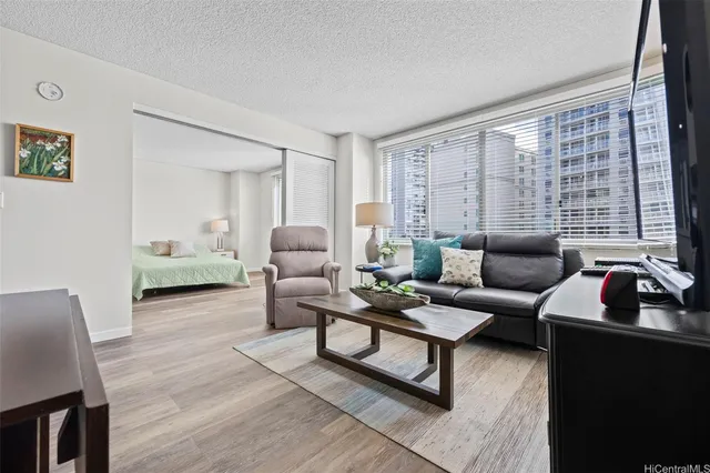 a view of a hallway with wooden floor and closet