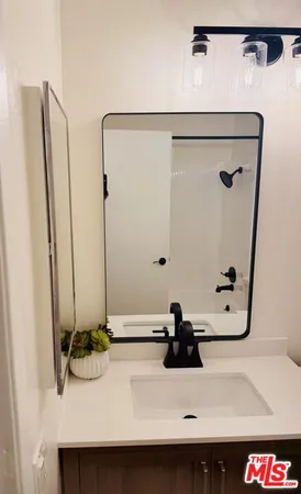 a bathroom with a toilet a sink a vanity and mirror