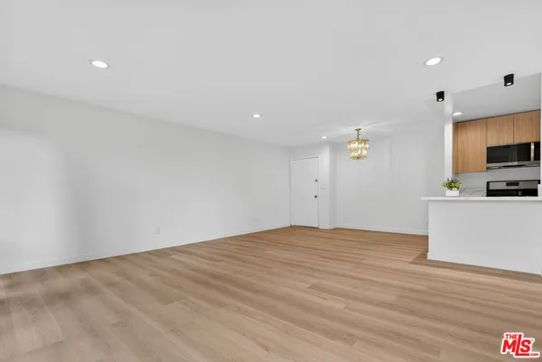 a living room with furniture a rug and a large window