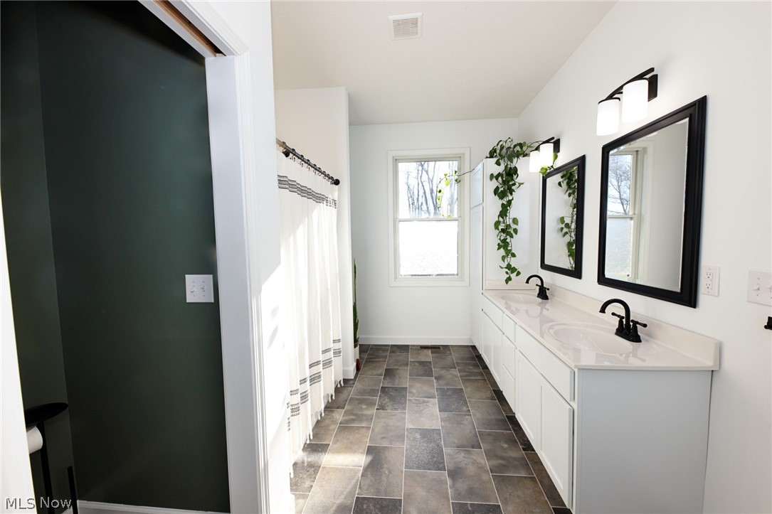 258 Friendly Acres Road Wellsburg, WV 26070 - Photo 20 of 47 Primary Bathroom featuring double vanity, curtained shower