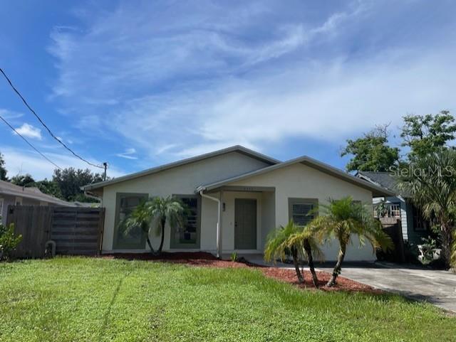 a view of a chair and table in backyard of the house