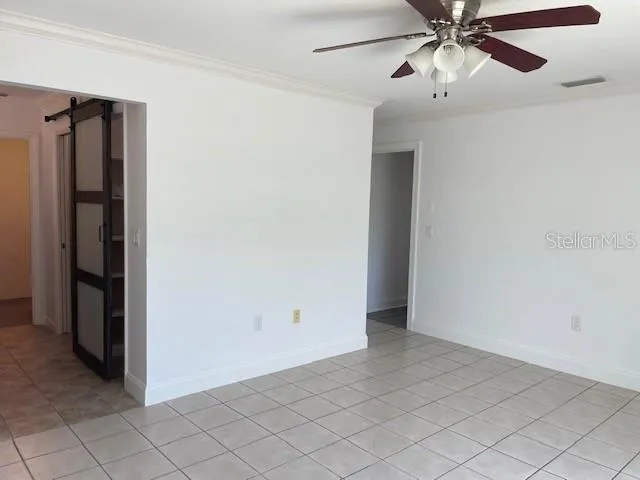 a view of a livingroom with a ceiling fan and window