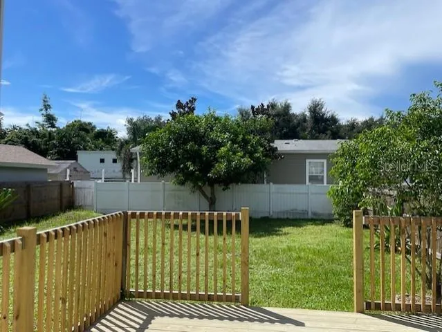 a view of house with a backyard