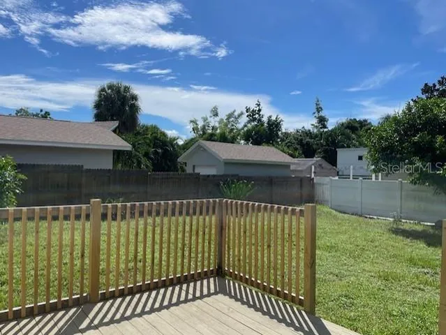 a view of a house with a wooden deck