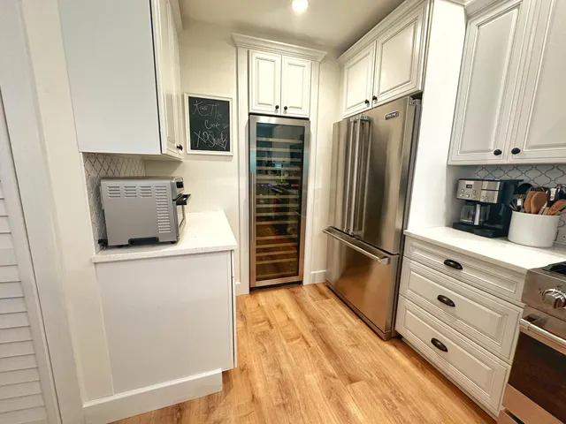 a kitchen with granite countertop a refrigerator stove and microwave