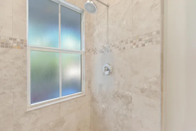 a bed room with a bed and a painting on the wall