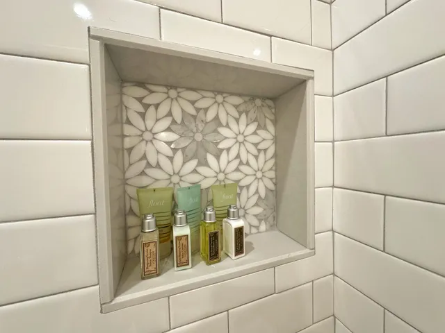 a view of a patio with couches chairs potted plants and floor to ceiling window