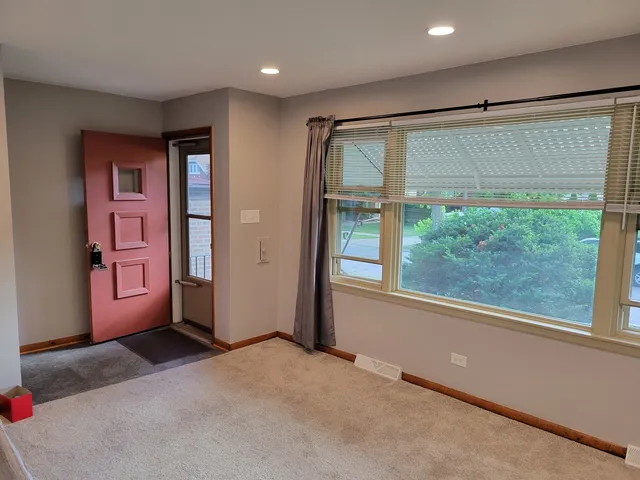 an empty room with windows and closet