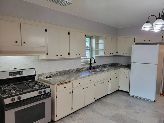 a kitchen with granite countertop cabinets and steel stainless steel appliances