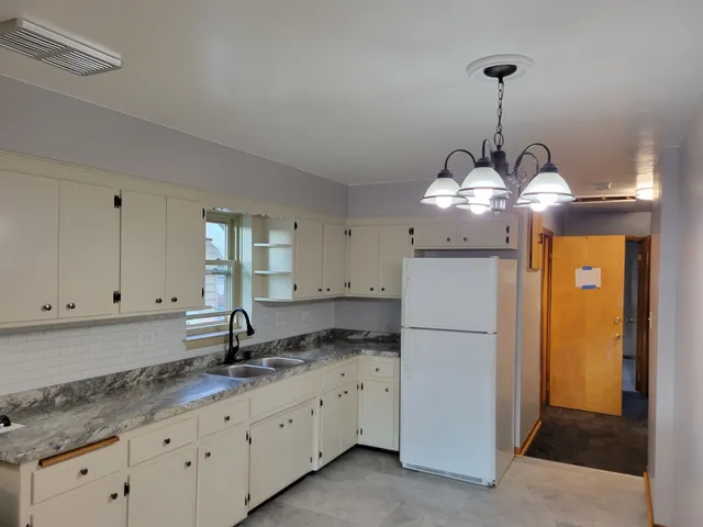 a kitchen with refrigerator and window
