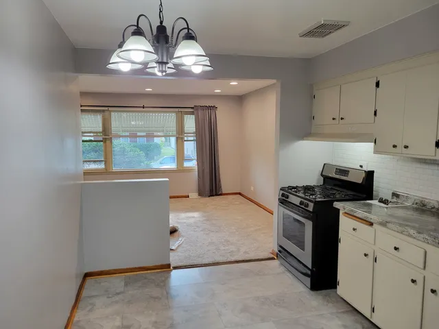 a kitchen with a stove and a sink