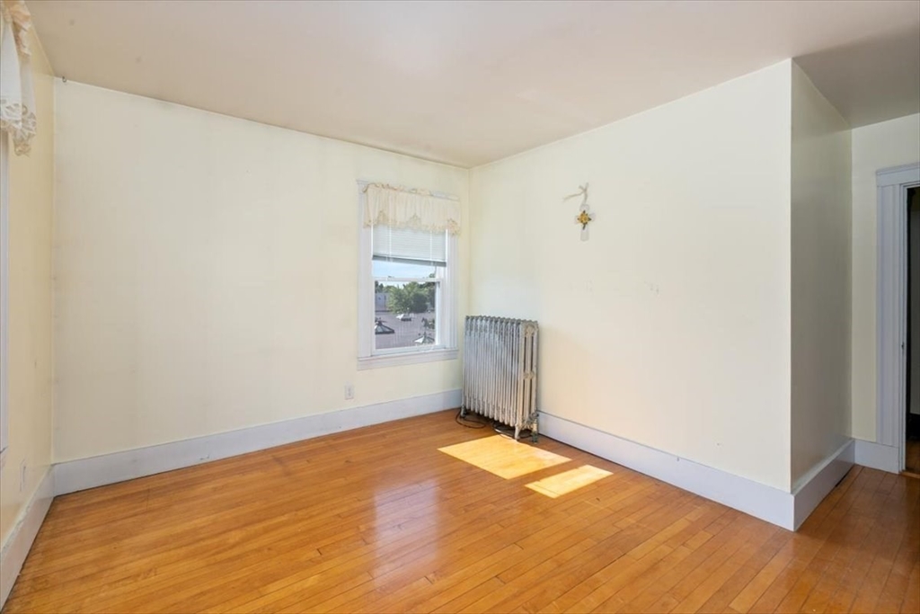 98 Webster Street Haverhill, MA 01830 - Photo 21 of 42 an empty room with wooden floor and windows