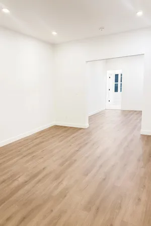 an empty room with wooden floor