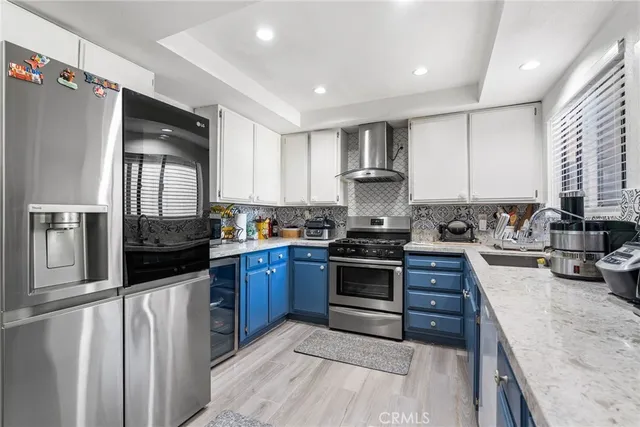 a kitchen with stainless steel appliances granite countertop a stove top oven a sink and dishwasher
