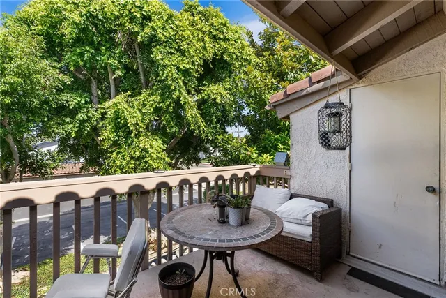 a view of balcony with wooden floor and outdoor seating