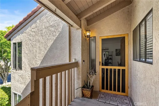 a view of a porch with wooden floor and fence