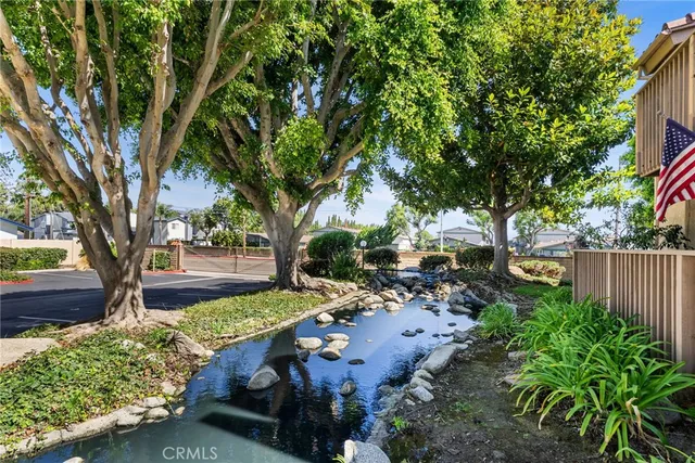 a view of yard with green space and trees