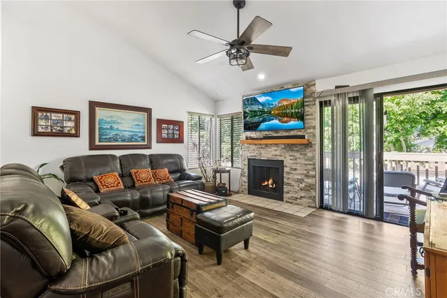 a living room with furniture a fireplace and a large window