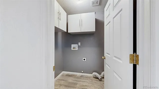 a patio with a table and chairs under an umbrella
