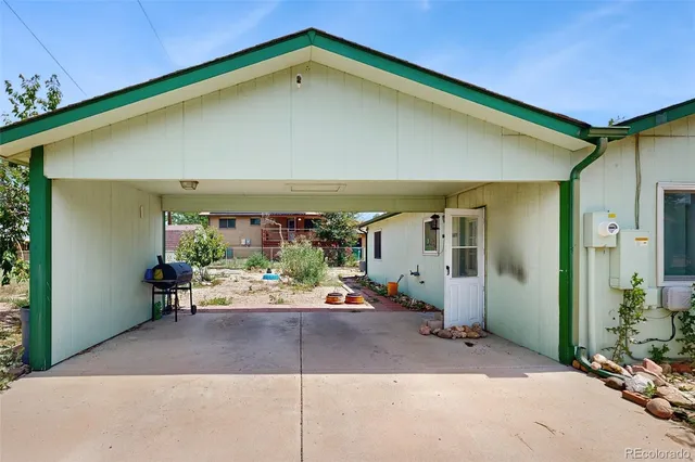 a backyard of a house with yard and outdoor seating