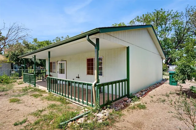 a view of a house with wooden fence
