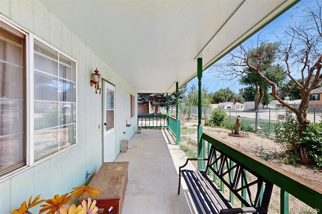 a kitchen with stainless steel appliances granite countertop a sink a stove a refrigerator a washer dryer and white cabinets