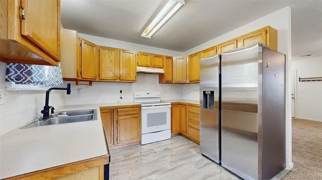 a kitchen with stainless steel appliances a stove sink and cabinets